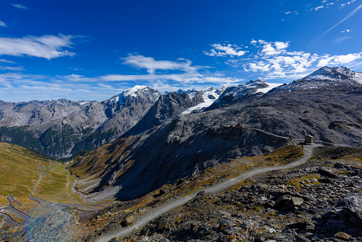 A winding mountain road in the Italian Alps near the Stelvio Pass.