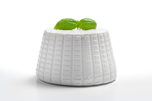 fresh ricotta with basil leaf on white background front view