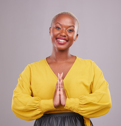 Woman, praying and hands together in religion, faith and hope or thank you of career opportunity on studio background. Christian or african person in gratitude portrait, peace emoji and ngo business