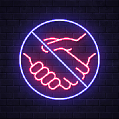 istock No handshake. Glowing neon icon on brick wall background 1755617449