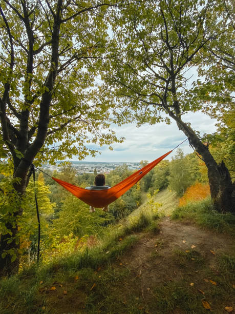 istock happy man chilling in hammock looking at autumn park 1755618048