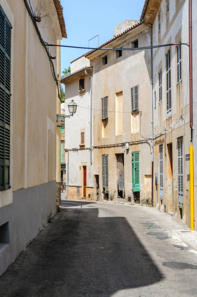A traditional narrow alley in the Jewish Medieval Quarter of the Spanish city of Palma de Mallorca, on the Balearic Mediterranean island of Mallorca, Spain.