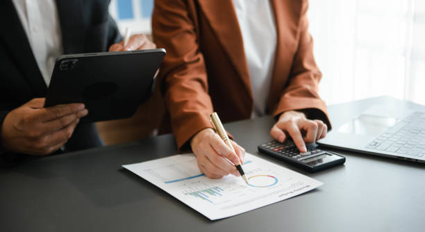 istock Business documents on office table with smart phone and calculator digital tablet and graph 1755625327