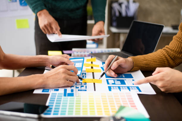 istock View of UI developer team brainstorming on their project with laptop, smartphone and digital tablet. Creative digital development agency. 1755625343