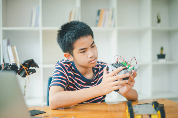 istock Asian boy learning and studying the work of technology robots.homeschool and science for tech project. playing childhood kids hobby leisure lifestyle people toys robotics technology. 1755626602