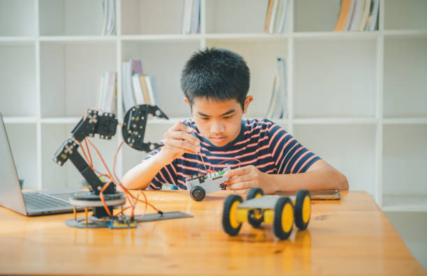 istock Asian boy learning and studying the work of technology robots.homeschool and science for tech project. playing childhood kids hobby leisure lifestyle people toys robotics technology. 1755627775
