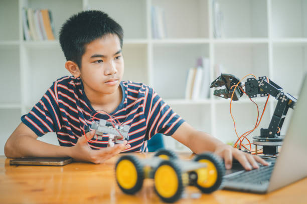 istock Asian boy learning and studying the work of technology robots.homeschool and science for tech project. playing childhood kids hobby leisure lifestyle people toys robotics technology. 1755629570