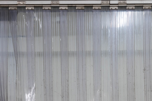 white PVC Curtain of food Industrial warehouse. plastic strip curtain at entrance door.