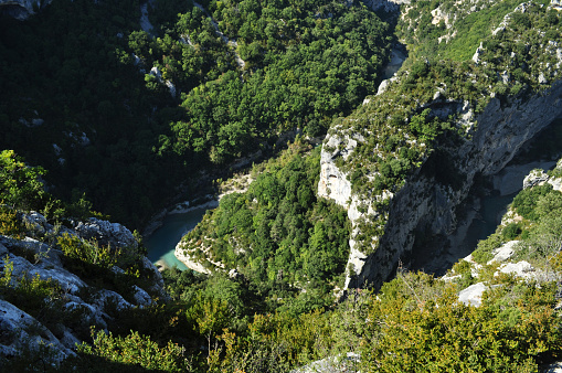 Verdon Canyon in the south of France in the Provence region. Rocks with cliffs and a deep valley with a river and a lake.