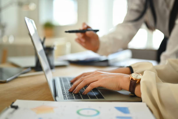 istock Business team using laptop and discussing business strategy information at co working space 1755644356