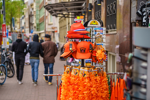 Orange clothes in souvenir shop in center of Amsterdam for King's Day celebration. AMSTERDAM,NETHERLANDS-28 APRIL,2019