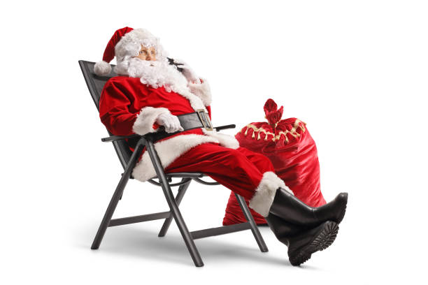istock Santa claus sitting in a foldable chair and making a phone call 1755645554