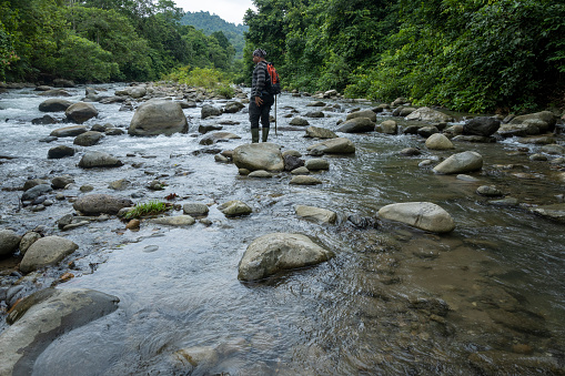 Men walking and riverwalking in the Ulu Masen ecosystem, Aceh, Indonesia