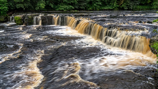 A scenic waterfall featuring two large cascading streams of water on either side