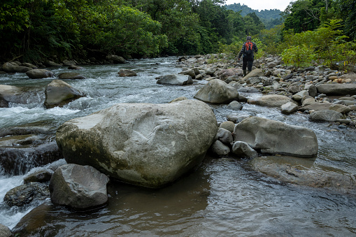 Men walking and riverwalking in the Ulu Masen ecosystem, Aceh, Indonesia