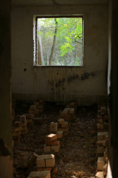 istock Ruined room with bricks that once supported the floor, outside the sun is shining 1755667275