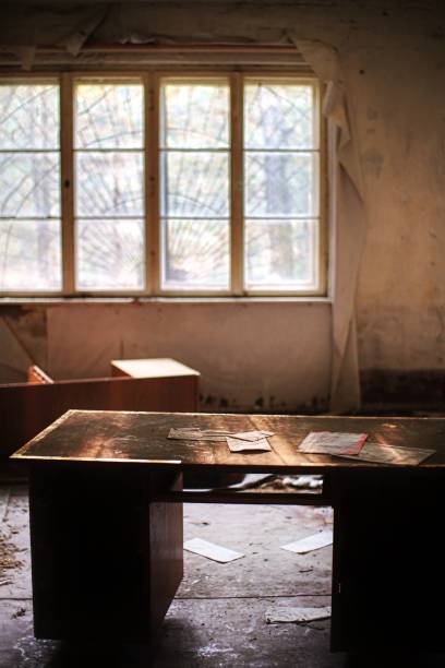 istock Desk with long forgotten documents in abandoned room 1755667293