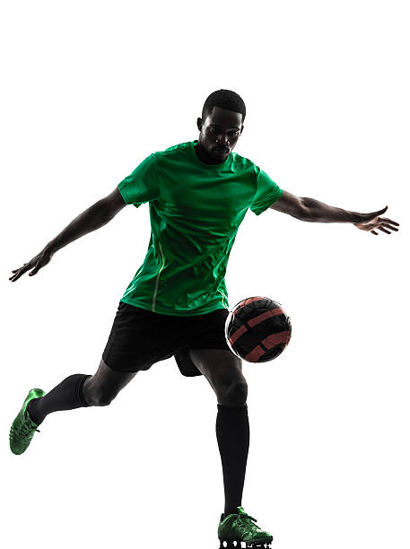 istock african man soccer player kicking silhouette 175566730