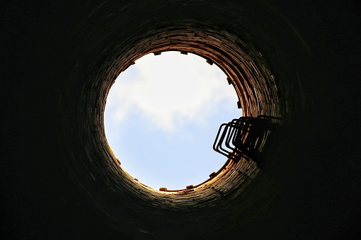 Upward view from inside of an old chimney.