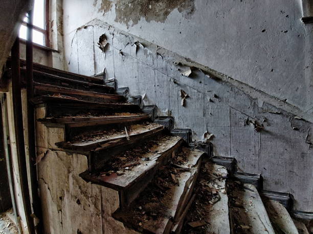 istock Noisy image of desolate staircase in an abandoned building 1755667344