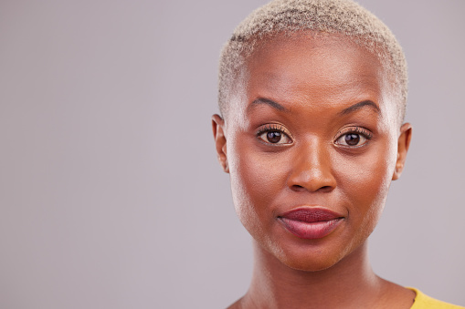 Raised eyebrows, portrait and woman in studio with a confused, suspicious or surprise face. Young, beautiful and African female model with shock facial expression by gray background with mockup space