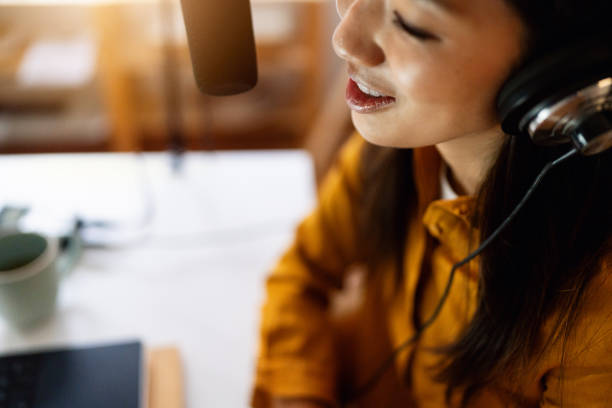 close up of female influencer japanese ethnicity, recording podcast from her home studio - recording studio sound recording equipment record interconnect imagens e fotografias de stock