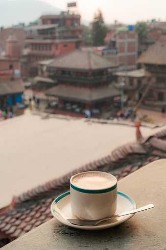 Cup of masala chai on table on the balcony view of Bhaktapur Durbar Square