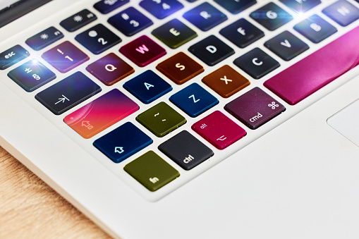 Laptop keyboard, color and technology for work, business and internet on a table. Digital, creative and pc computer for electronic entertainment, gaming or web on a desk for streaming and creativity