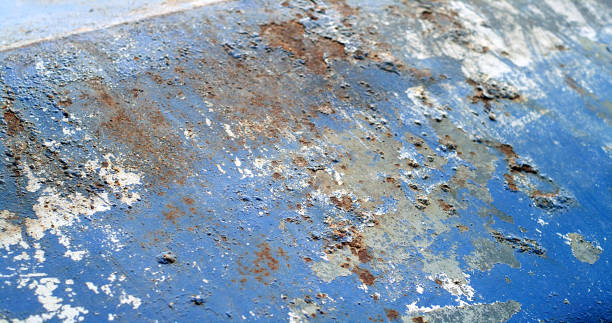 istock Boat DIY restoration. Damaged and rusted metal surface with paint falling off 1755697735
