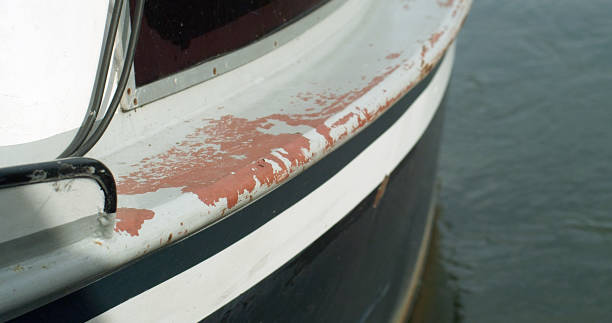 Close up image of very old ship propeller and blue wooden ship rudder background