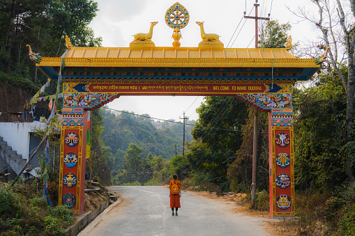 Woman standing at the gate to  Namo Buddha monastery in Nepal