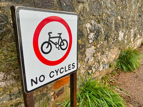 Photograph of no cycling sign in front of a brick wall