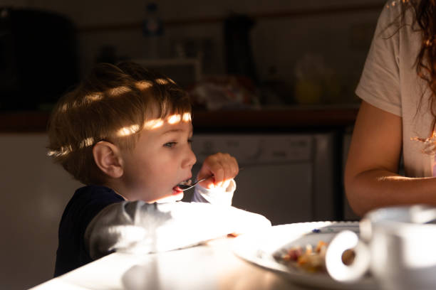 istock Adorable little boy eats breakfast with a spoon 1755701125