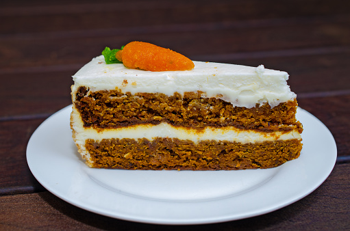 Carrot sponge cake with cream and walnuts. High quality photo