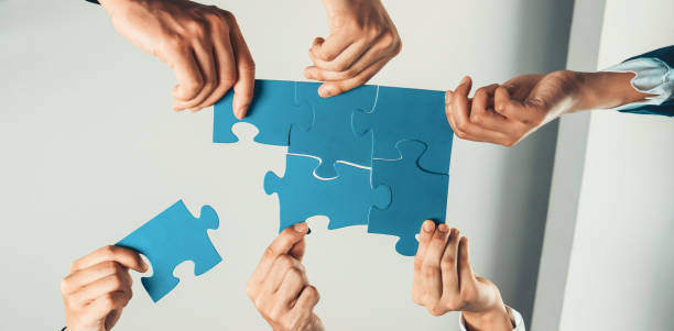 istock Top view panorama banner of business team assembling jigsaw puzzle. Shrewd 1755716553