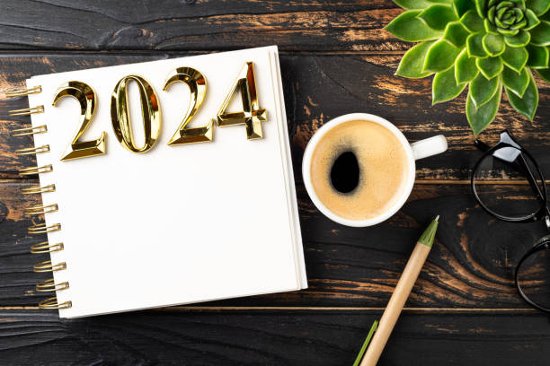 istock New year resolutions 2024 on desk. 2024 resolutions list with notebook, coffee cup on table. Goals, resolutions, plan, action, checklist concept. New Year 2024 template 1755718776