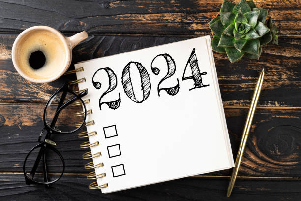 new year resolutions 2024 on desk. 2024 resolutions list with notebook, coffee cup on table. goals, resolutions, plan, action, checklist concept. new year 2024 template - determination new years eve list aspirations imagens e fotografias de stock