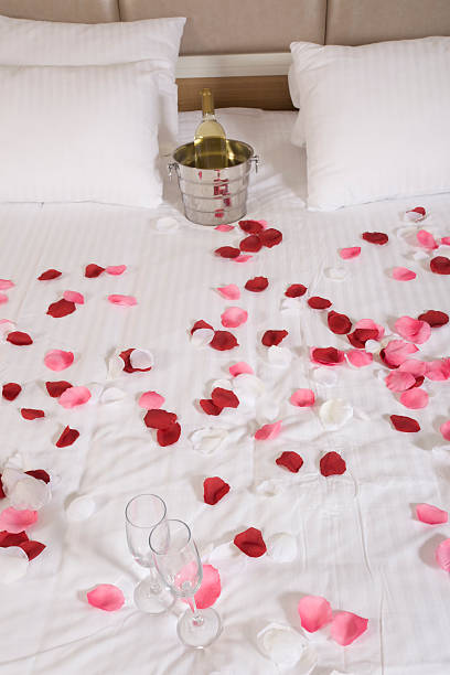 istock hotel room with big bed and red flowers 175572002