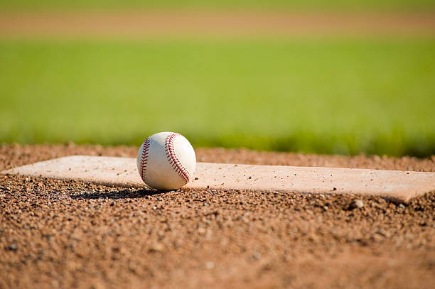 Baseball on a mound with the field in the background stock photo