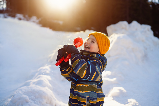 Little boy having fun in the snow.