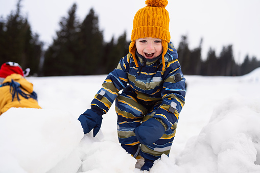 Little boy having fun in the snow.