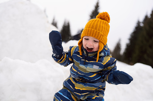 Little boy having fun in the snow.