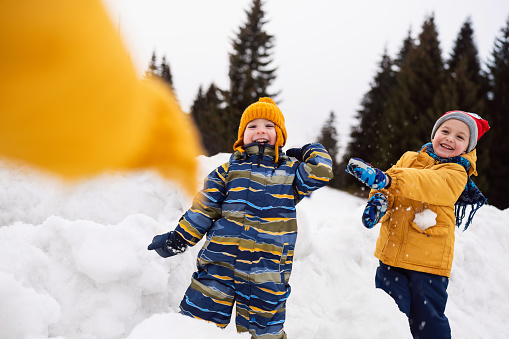 Little boys having fun in the snow.
