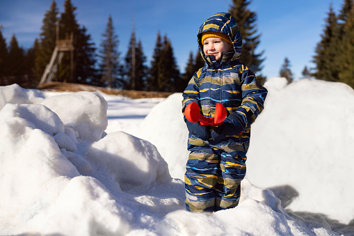 Little boy having fun in the snow.