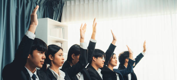 istock Business team or office workers raising their hands to ask question. Shrewd 1755733071