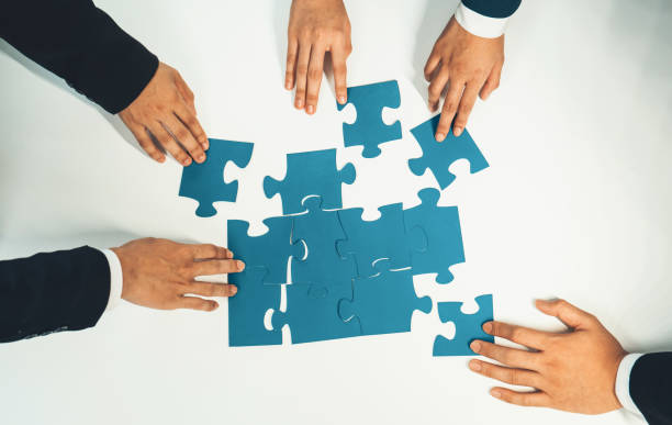 istock Top view panorama banner of business team assembling jigsaw puzzle. Shrewd 1755741175