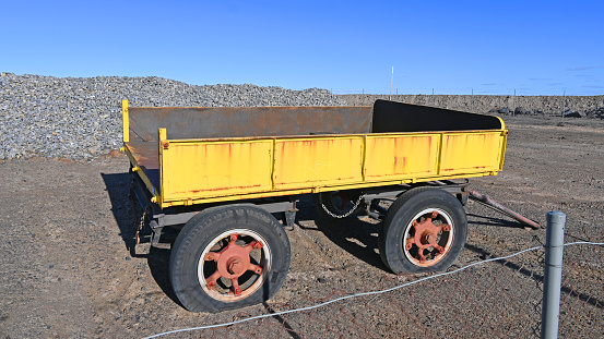 Old yellow mining cart in on an old abandond mine site