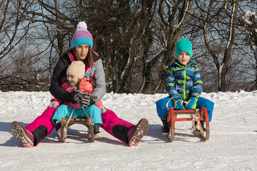 The family enjoys their first skiing adventure together. Winter is the right time for children to gain a love for nature by fully indulging in winter magic such as skiing, snowshoeing, making snowmen and sledding.