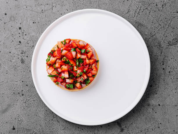 strawberry tartlet on grey stone background