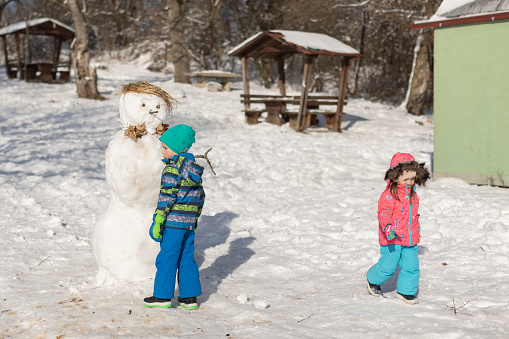 The family enjoys their first skiing adventure together. Winter is the right time for children to gain a love for nature by fully indulging in winter magic such as skiing, snowshoeing, making snowmen and sledding.